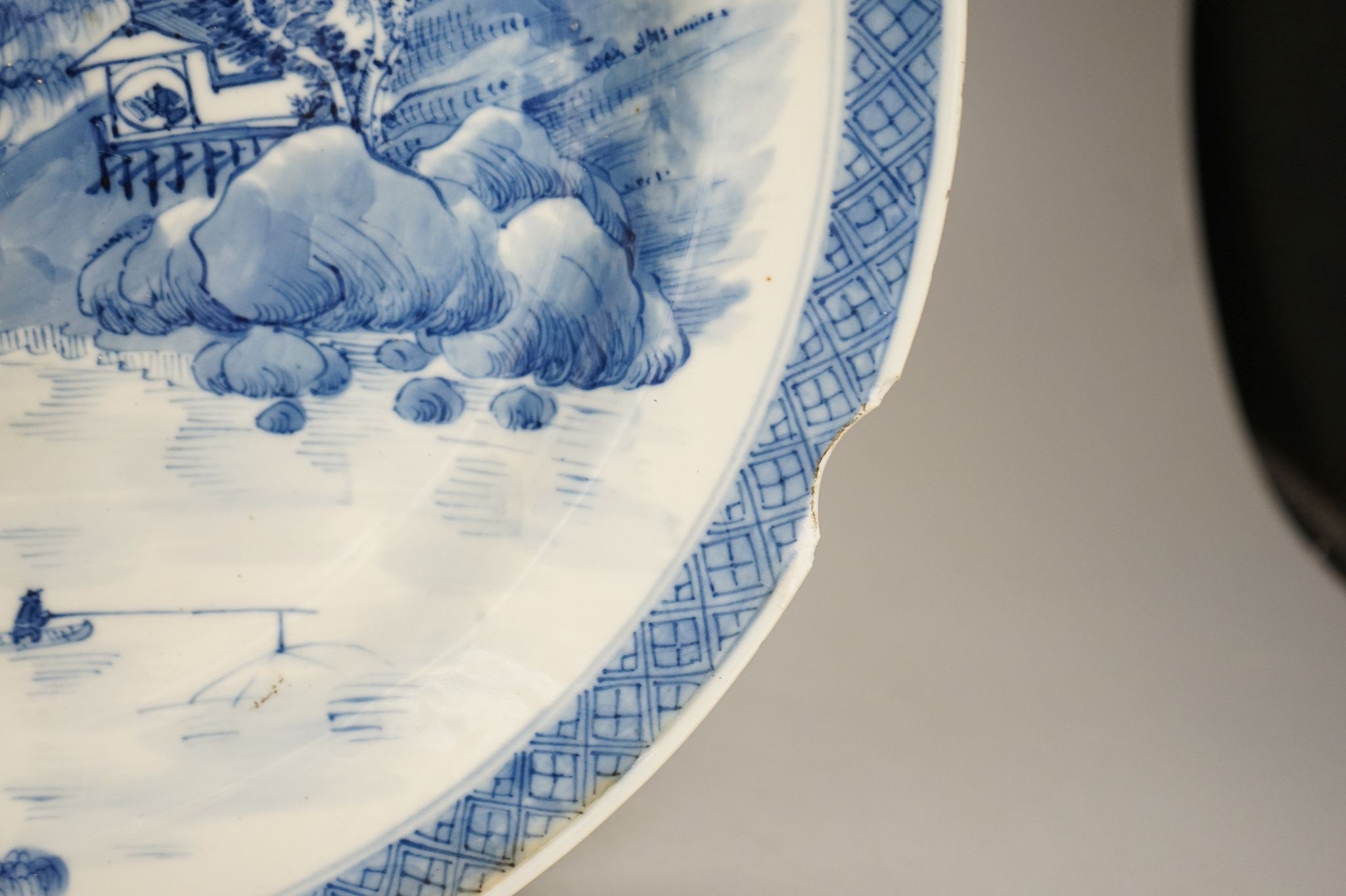 A Chinese blue and white landscape dish, Kangxi mark but 19th century, 36cm